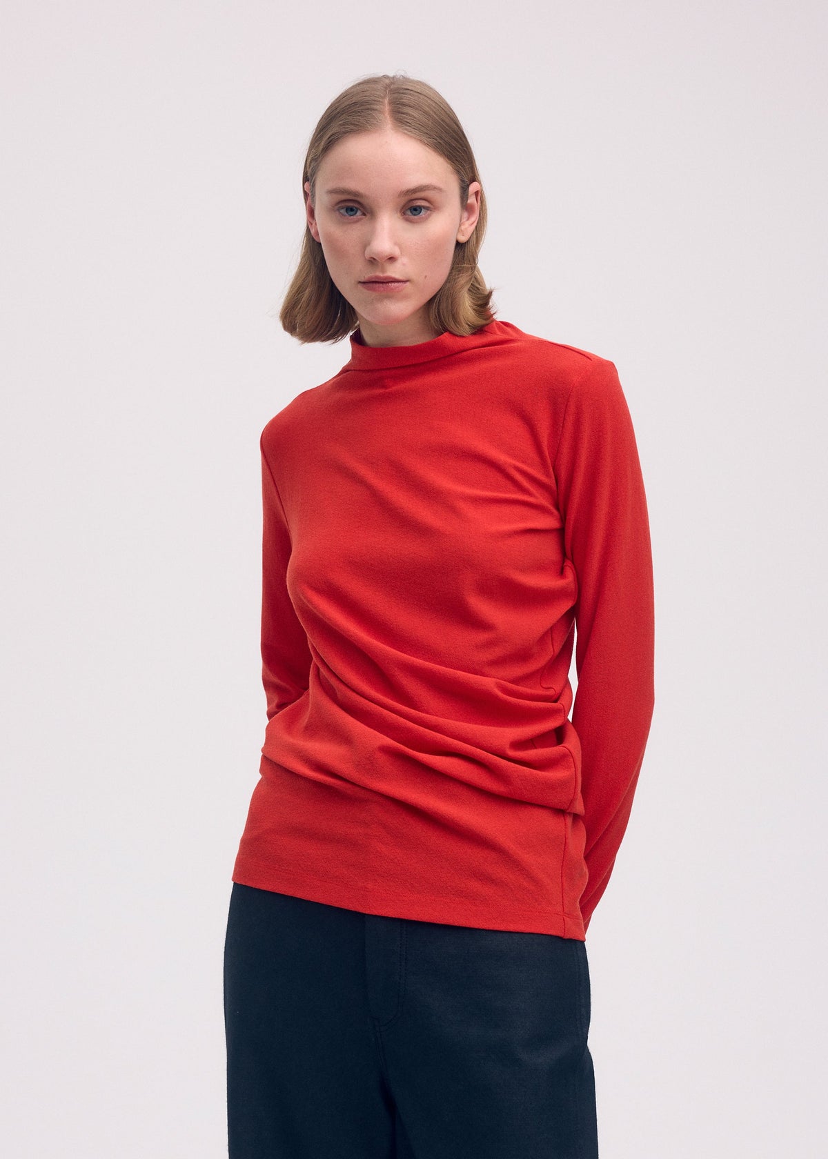 A model wears the Issey Miyake THREE SLEEVED JERSEY shirt.