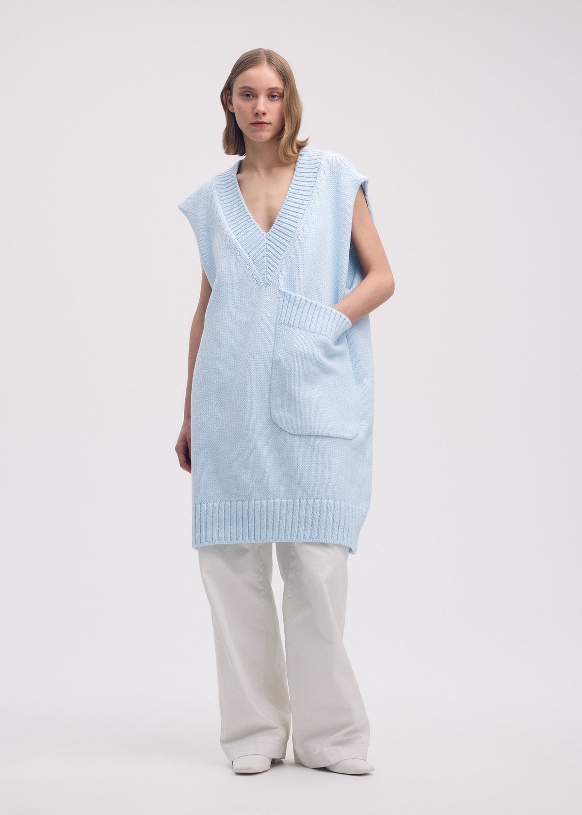 A model wears the Issey Miyake BREEZE KNIT vest.