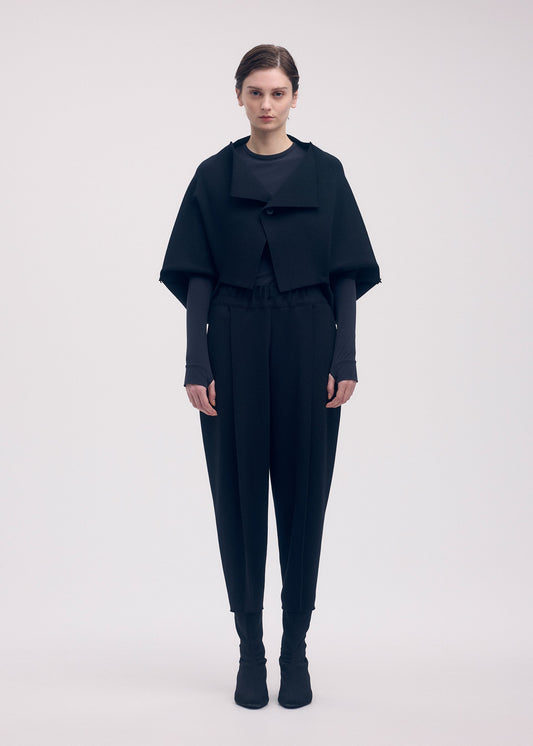 A model wears the ISSEY MIYAKE CAMPAGNE trousers.