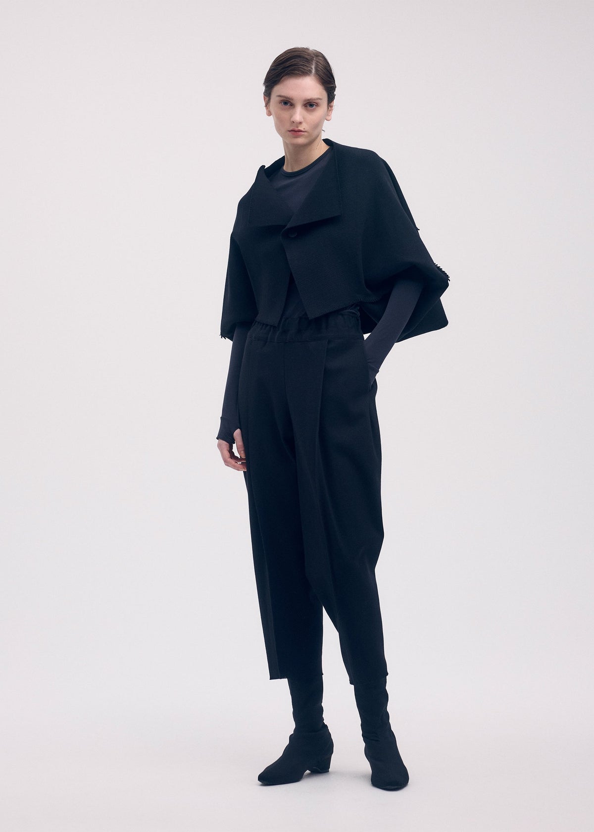 A model wears the ISSEY MIYAKE CAMPAGNE trousers.