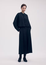 A model wears the ISSEY MIYAKE CAMPAGNE trousers.