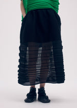 A model wears the Issey Miyake MOVING KNIT skirt.