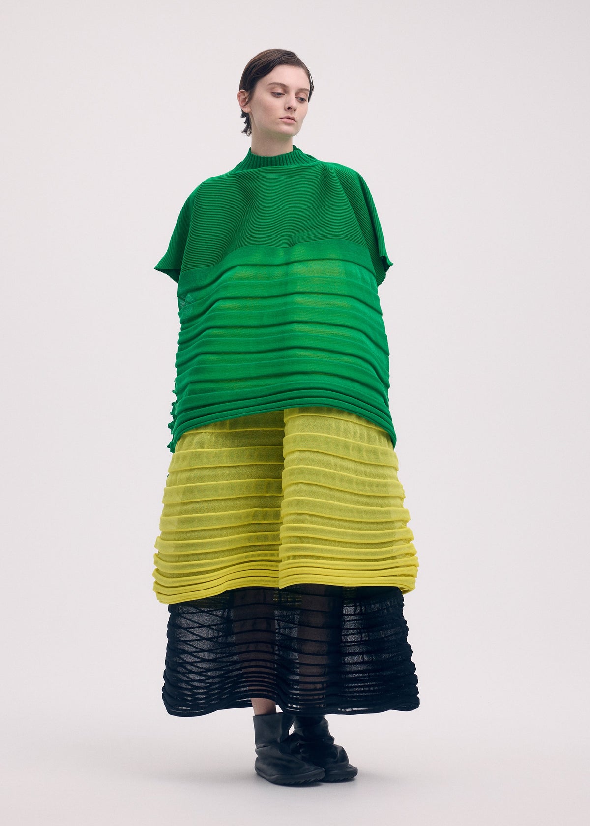 A model wears the Issey Miyake MOVING KNIT skirt.