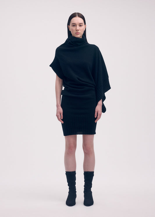 A model wears the Issey Miyake CROOKED WOOL KNIT dress.