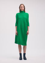 A model wears the Issey Miyake COTTON CASHMERE KNIT dress.