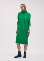 A model wears the Issey Miyake COTTON CASHMERE KNIT dress.
