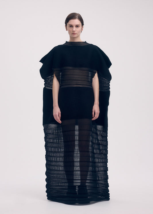 A model wears the Issey Miyake MOVING KNIT dress.
