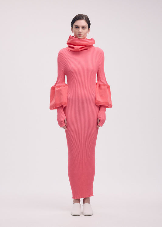 A model wears the ISSEY MIYAKE THIN AND THICK KNIT dress.