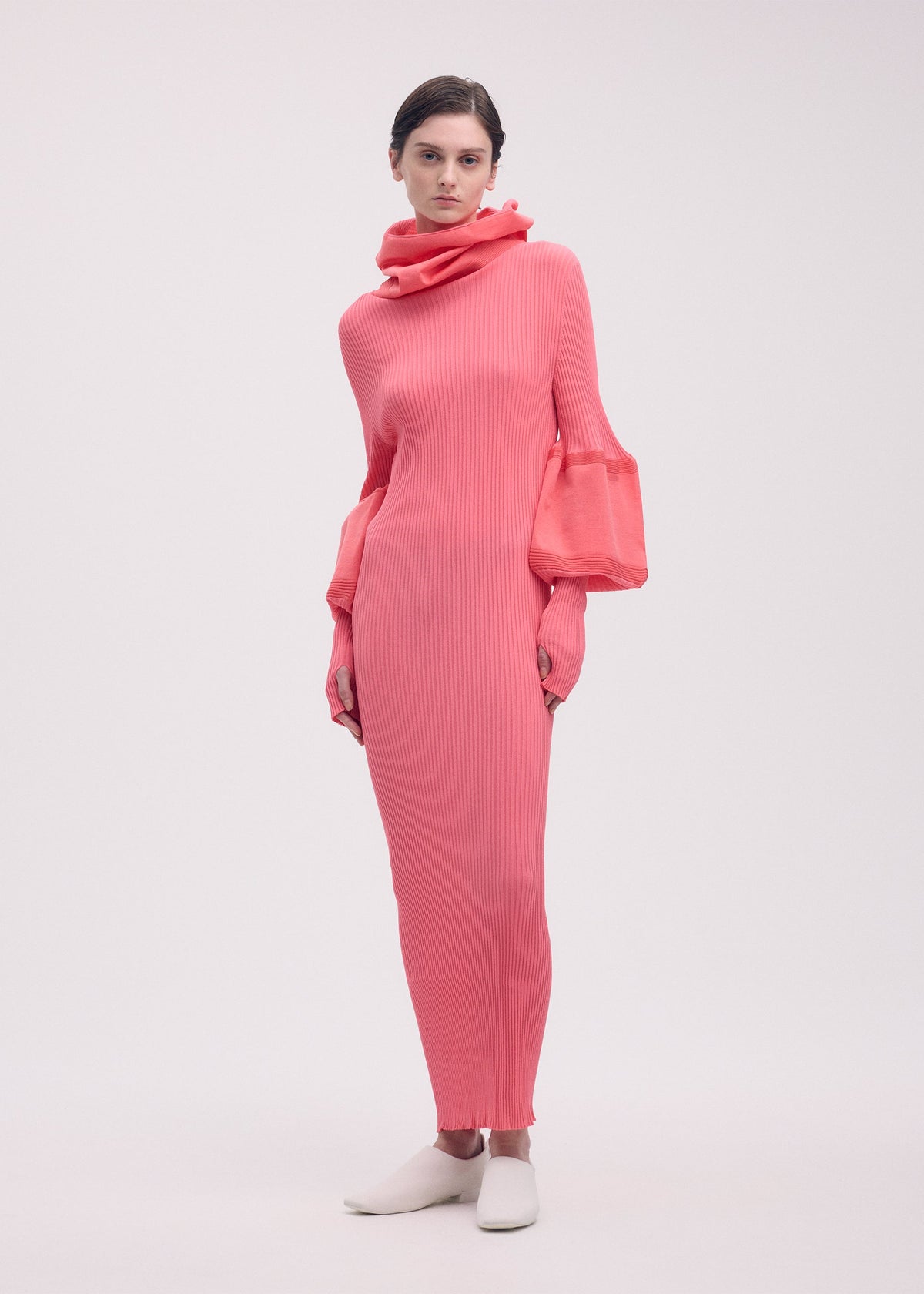 A model wears the ISSEY MIYAKE THIN AND THICK KNIT dress.