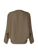 A detail shot of the ISSEY MIYAKE CAMPAGNE top.