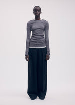 A model wears the Issey Miyake SEEN UNSEEN AP top.