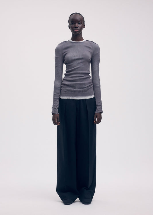 A model wears the Issey Miyake SEEN UNSEEN AP top.