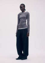 A model wears the Issey Miyake SEEN UNSEEN AP top.
