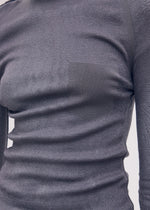 A model wears the Issey Miyake SEEN UNSEEN AP top.