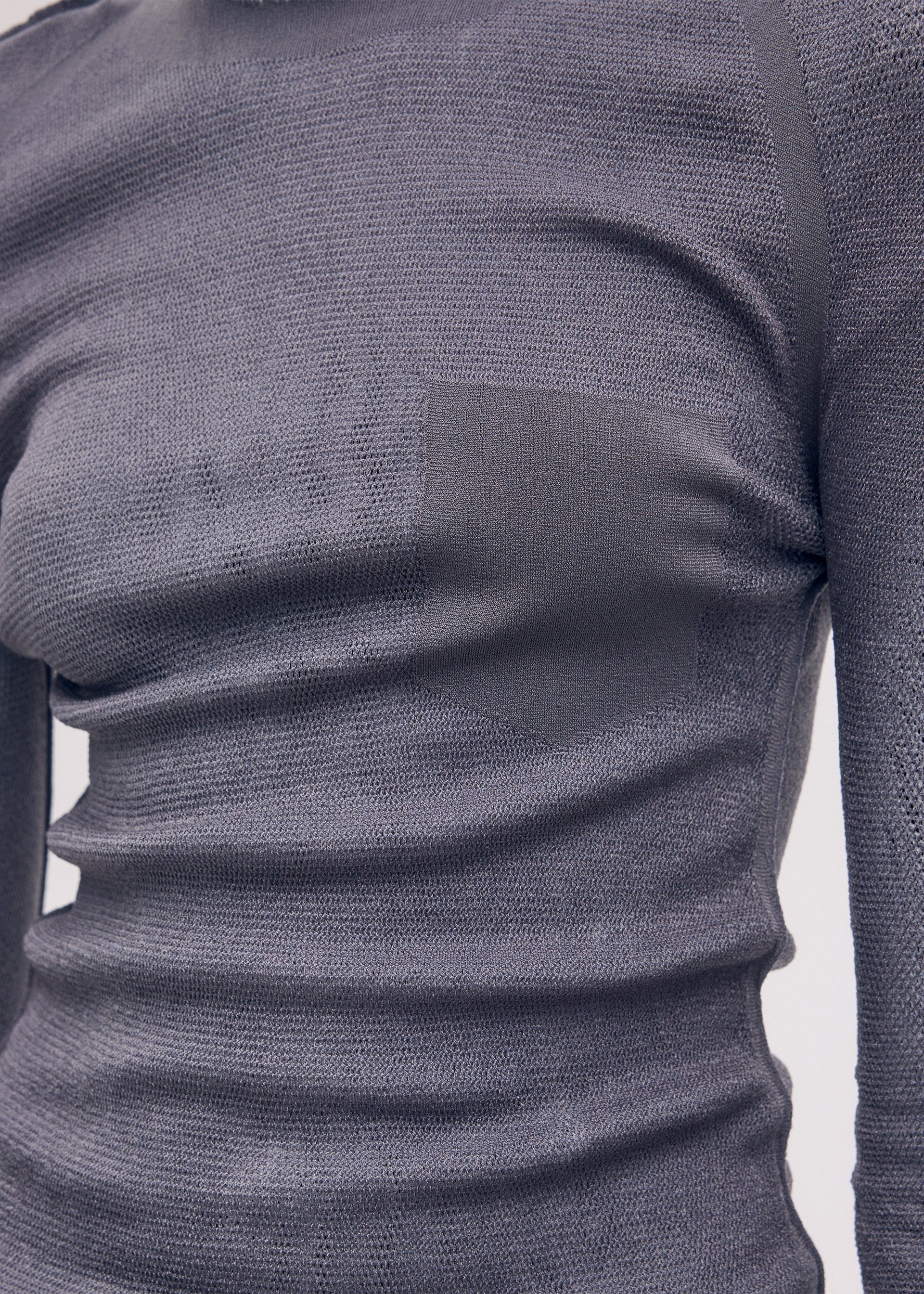 A model wears the Issey Miyake SEEN UNSEEN AP top.