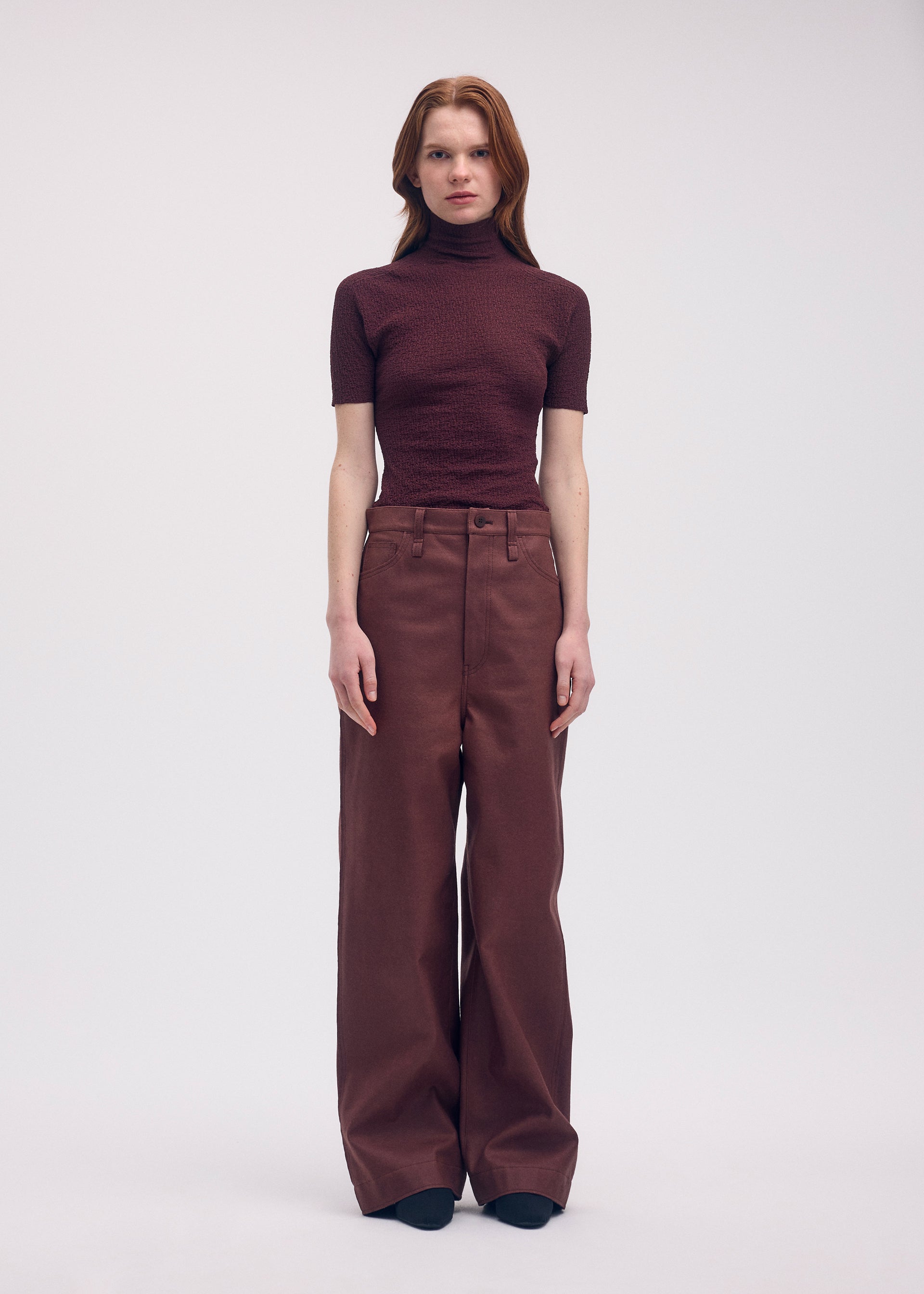 A model wears the Issey Miyake BODY KNIT top.