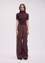 A model wears the Issey Miyake BODY KNIT top.