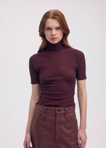 A model wears the Issey Miyake BODY KNIT top.