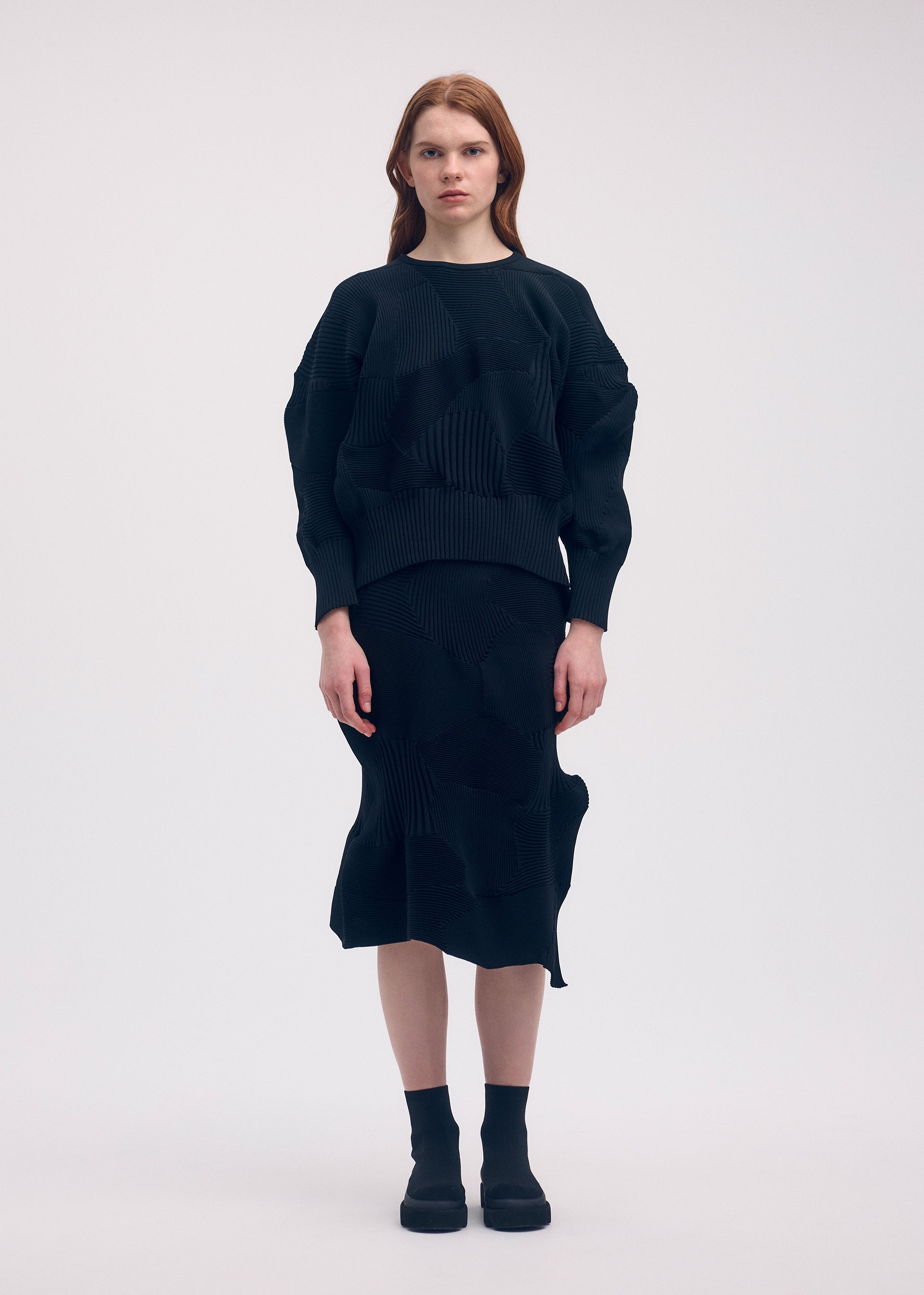 A model wears the Issey Miyake KONE KONE top.