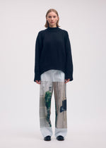 A model wears the Issey Miyake BREEZE KNIT top.