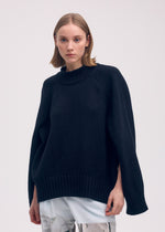 A model wears the Issey Miyake BREEZE KNIT top.