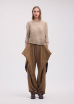 A model wears the Issey Miyake COTTON CASHMERE KNIT top.