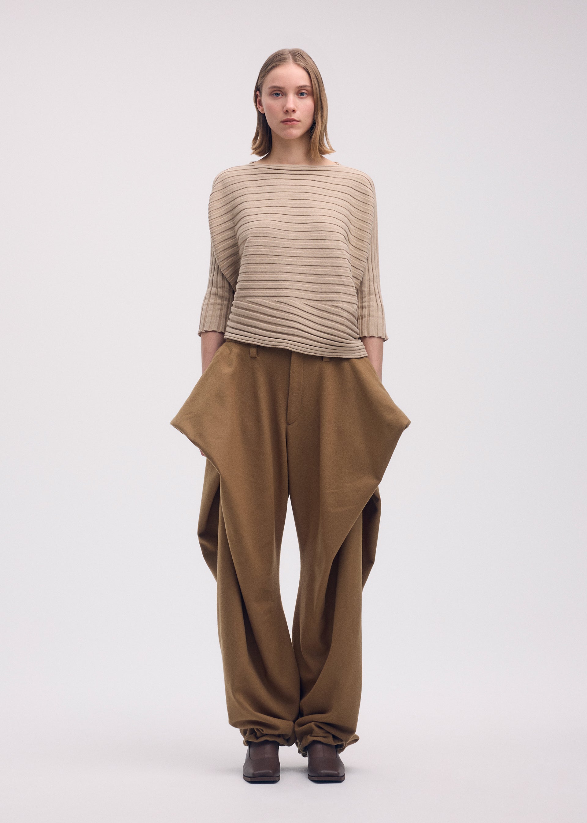 A model wears the Issey Miyake COTTON CASHMERE KNIT top.