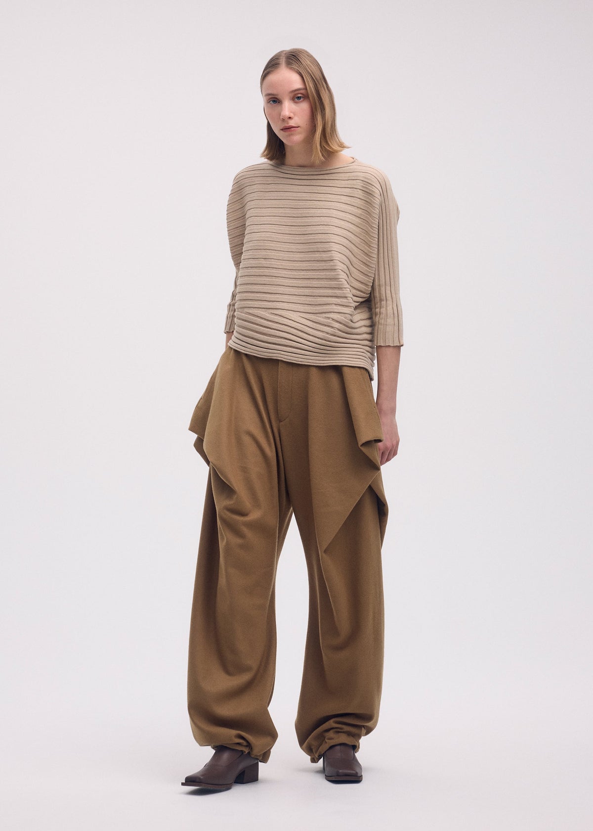 A model wears the Issey Miyake COTTON CASHMERE KNIT top.