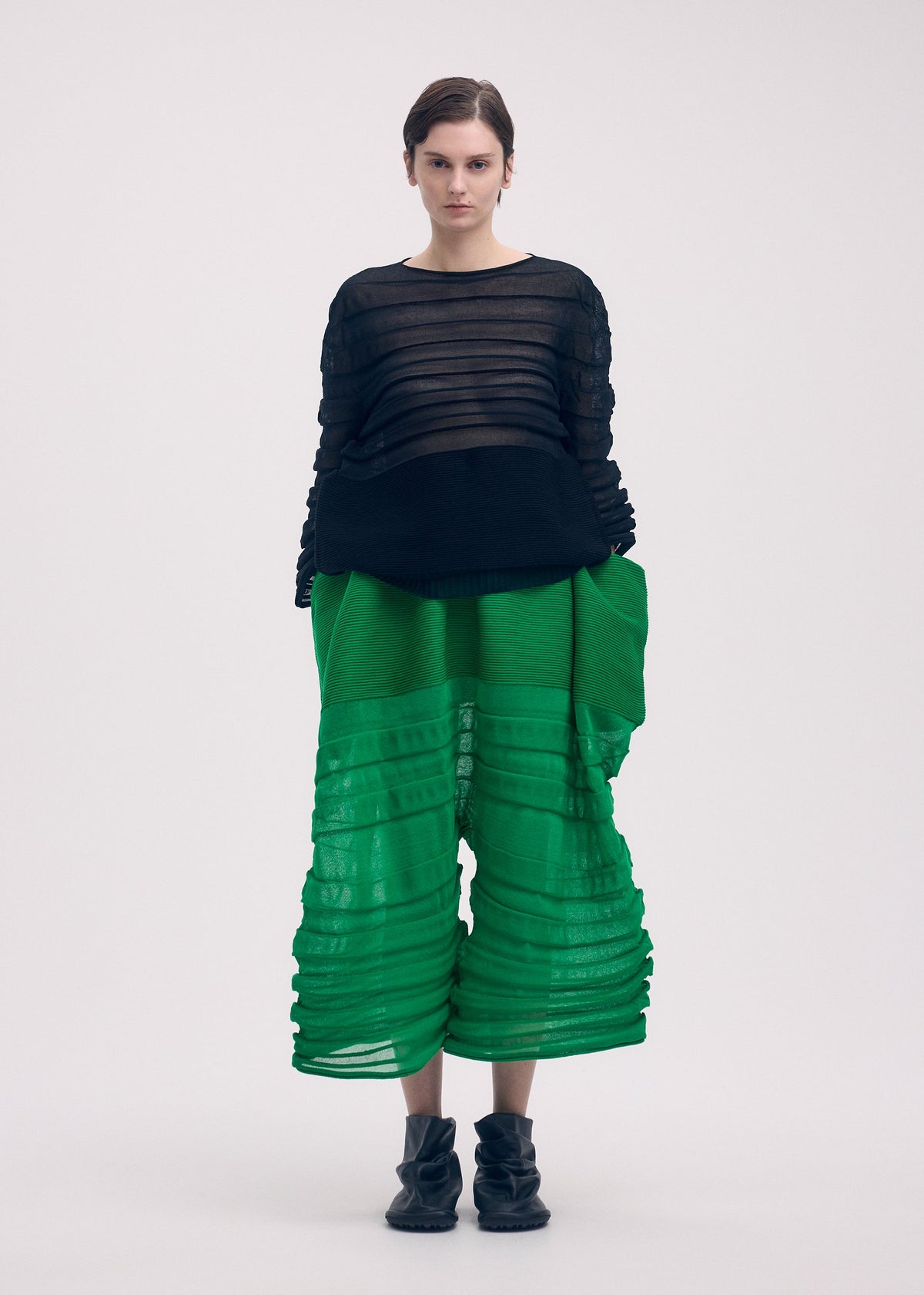 A model wears the Issey Miyake MOVING KNIT top.