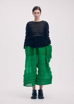 A model wears the Issey Miyake MOVING KNIT top.