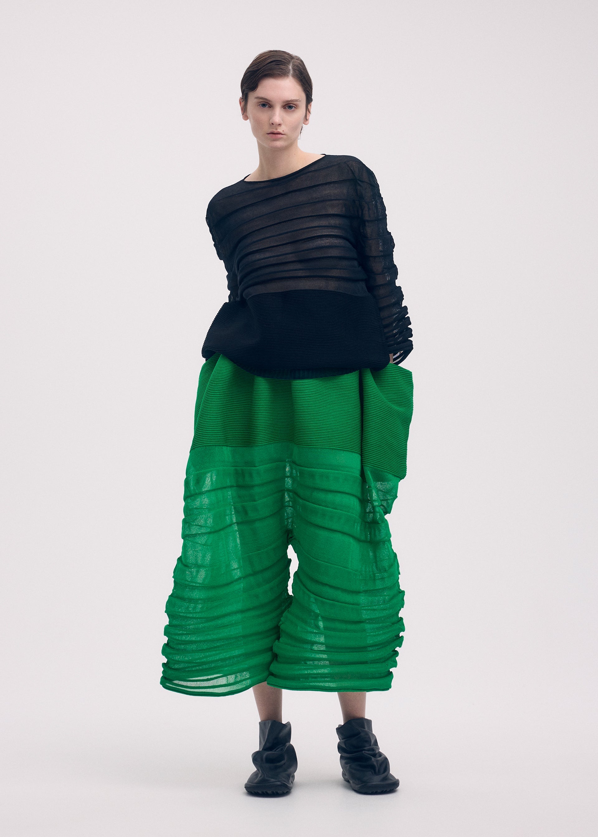 A model wears the Issey Miyake MOVING KNIT top.