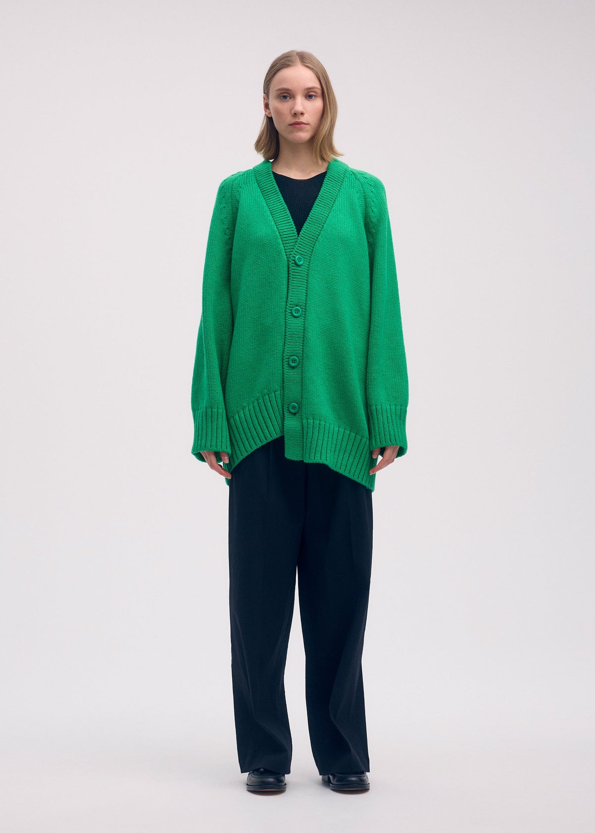 A model wears the Issey Miyake BREEZE KNIT cardigan.