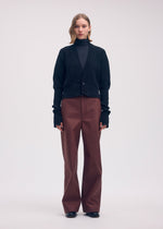 A model wears the ISSEY MIYAKE DISPLACED KNIT cardigan.