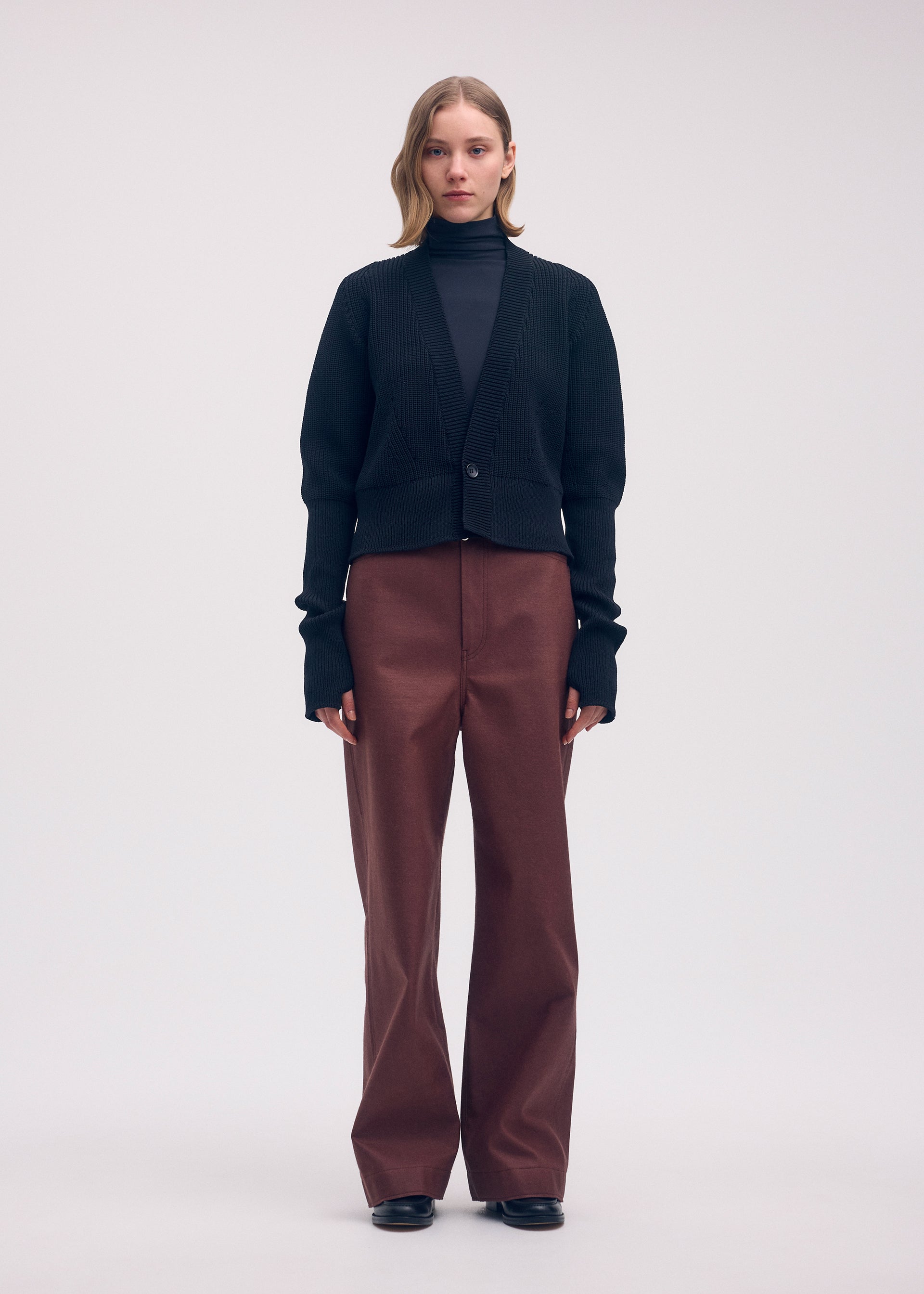 A model wears the ISSEY MIYAKE DISPLACED KNIT cardigan.