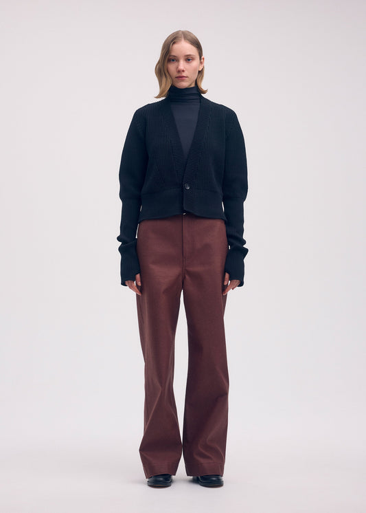 A model wears the ISSEY MIYAKE DISPLACED KNIT cardigan.