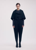 A model wears the ISSEY MIYAKE CAMPAGNE cardigan.