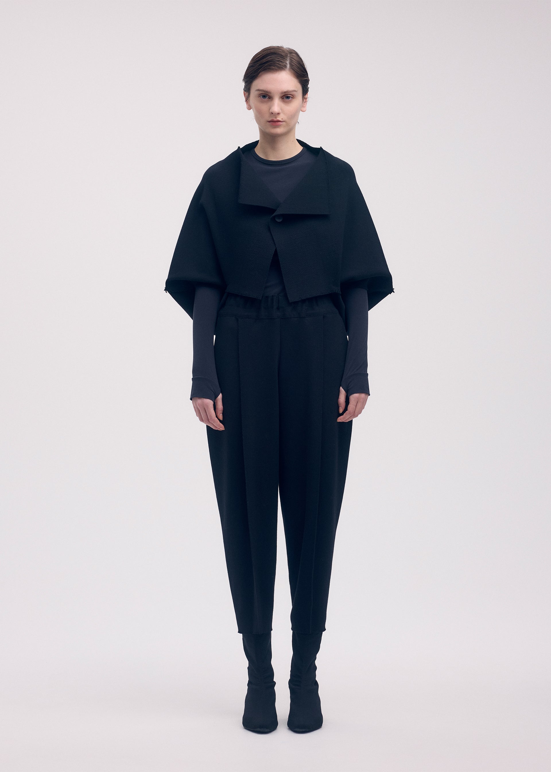 A model wears the ISSEY MIYAKE CAMPAGNE cardigan.