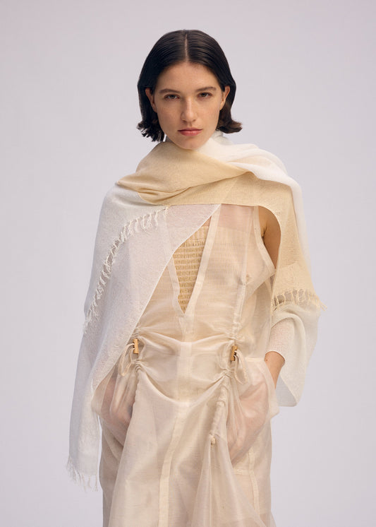 A model wears the ISSEY MIYAKE SLITS STOLE stole.