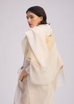 A model wears the ISSEY MIYAKE SLITS STOLE stole.