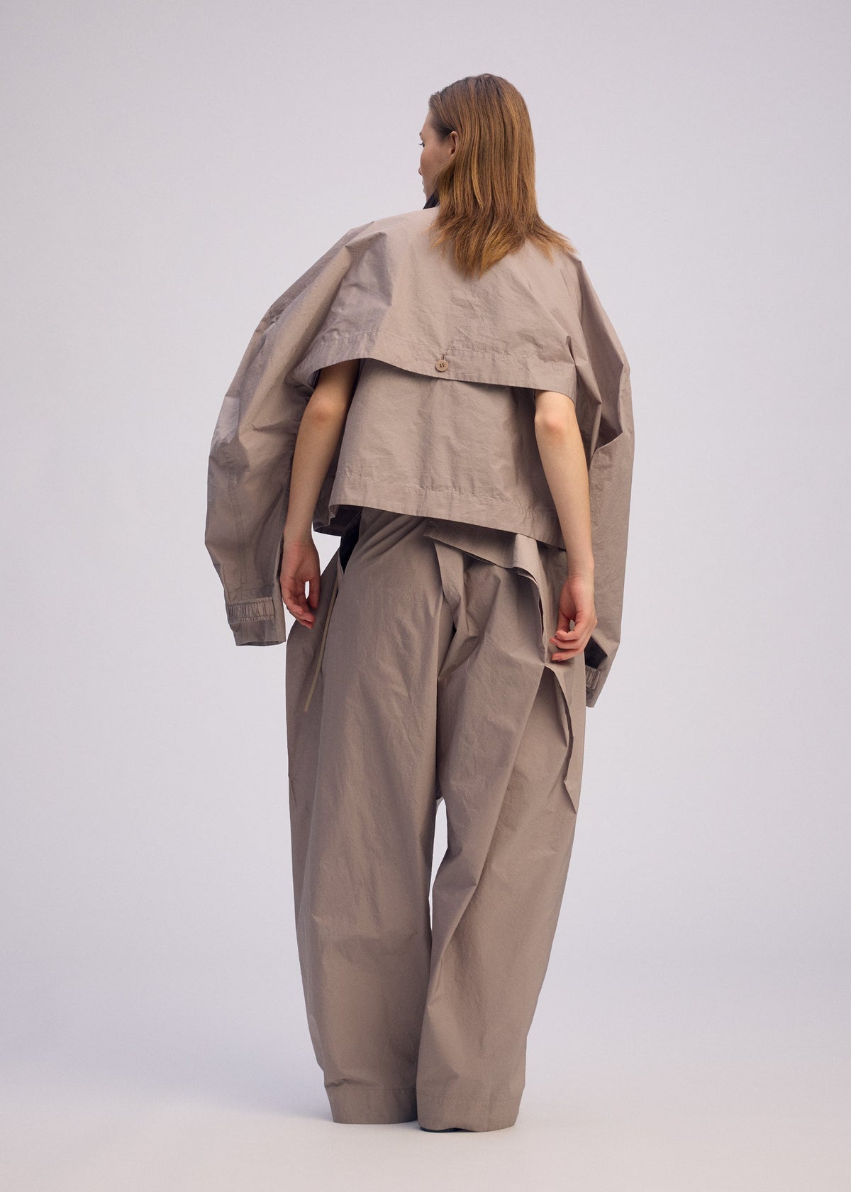A model wears the ISSEY MIYAKE AKIMBO prêt à porter.