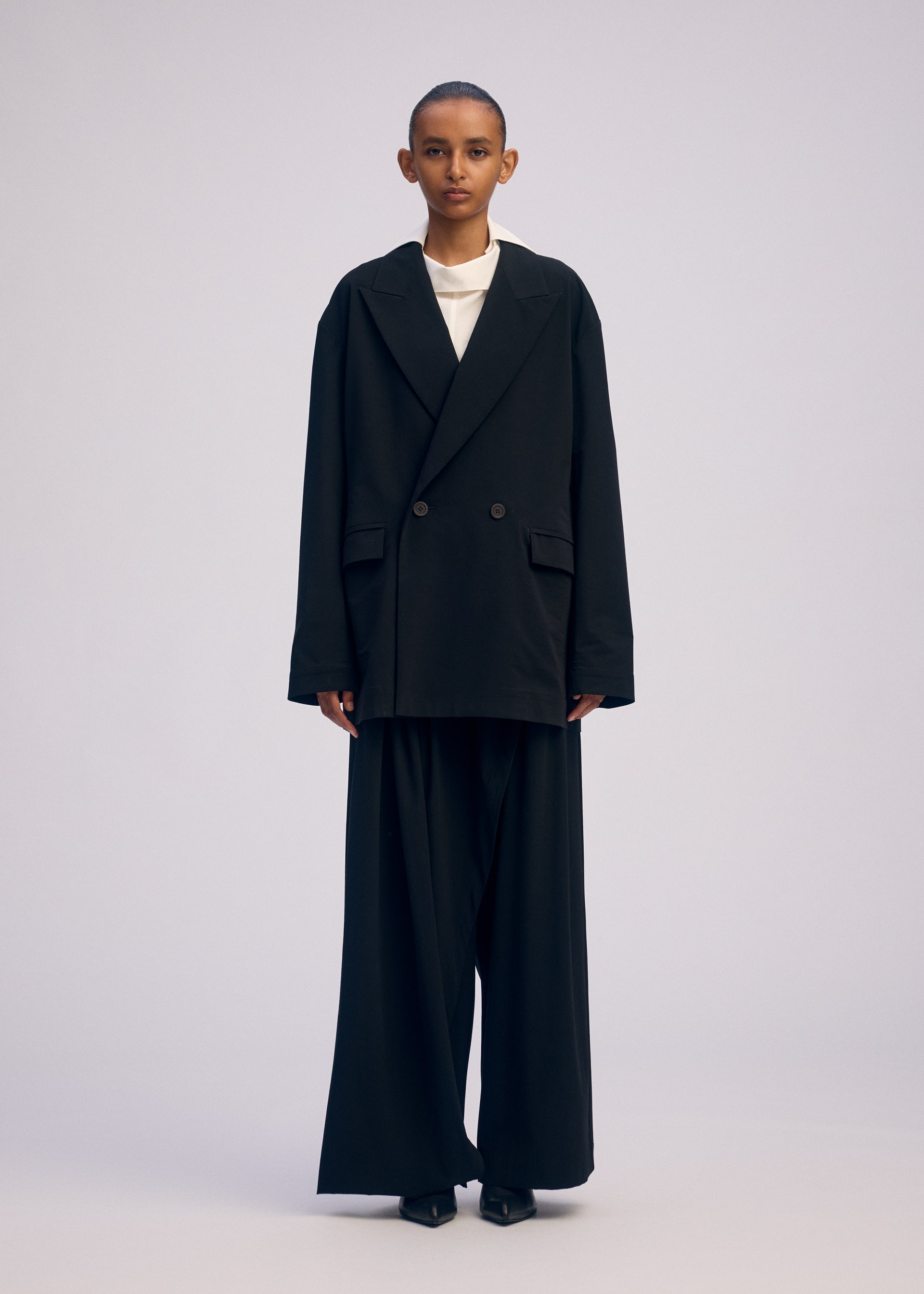 A model wears the Issey Miyake LOOPED jacket.