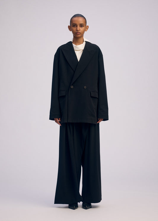 A model wears the Issey Miyake LOOPED jacket.