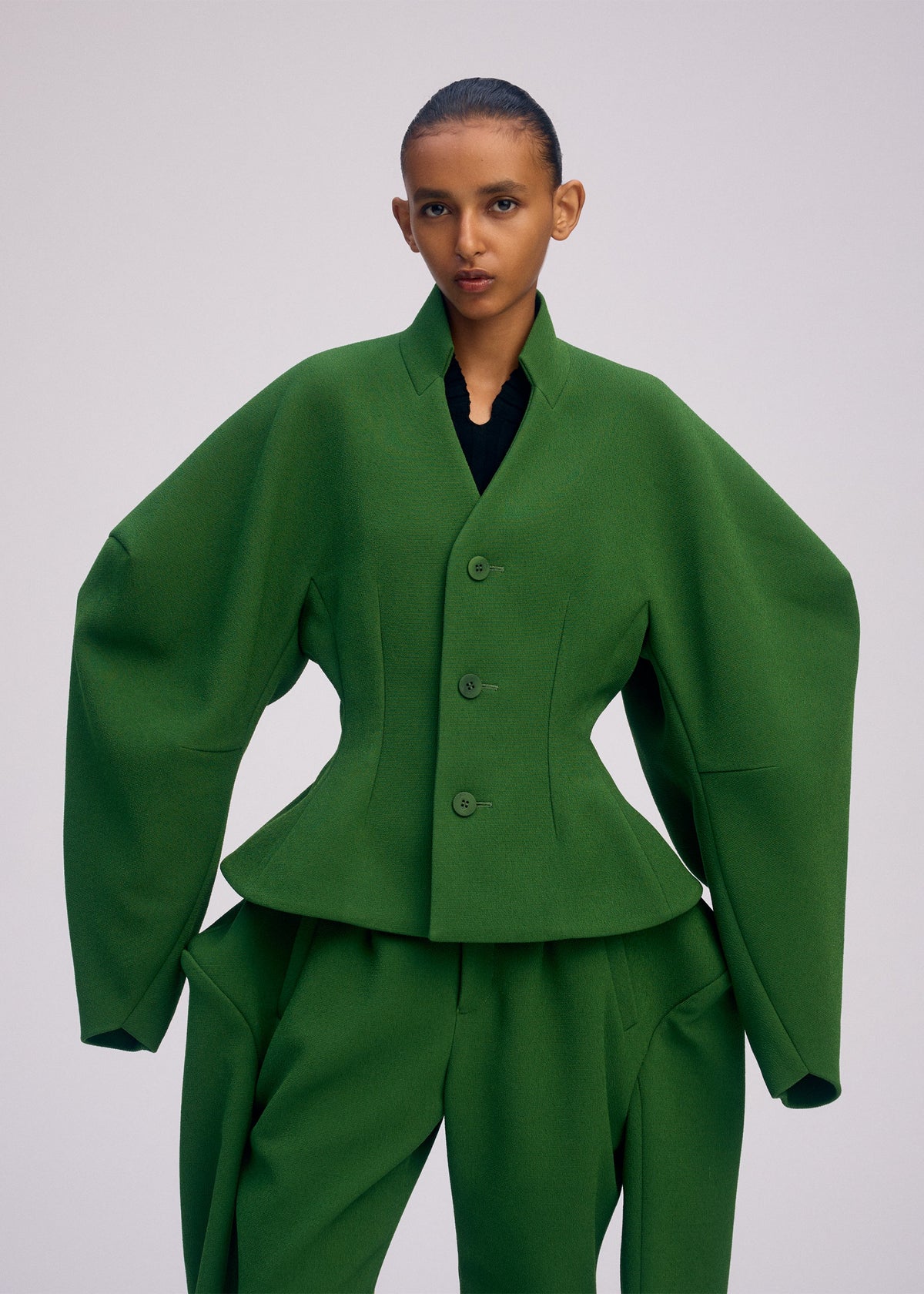 A model wears the ISSEY MIYAKE ARMS prêt à porter.