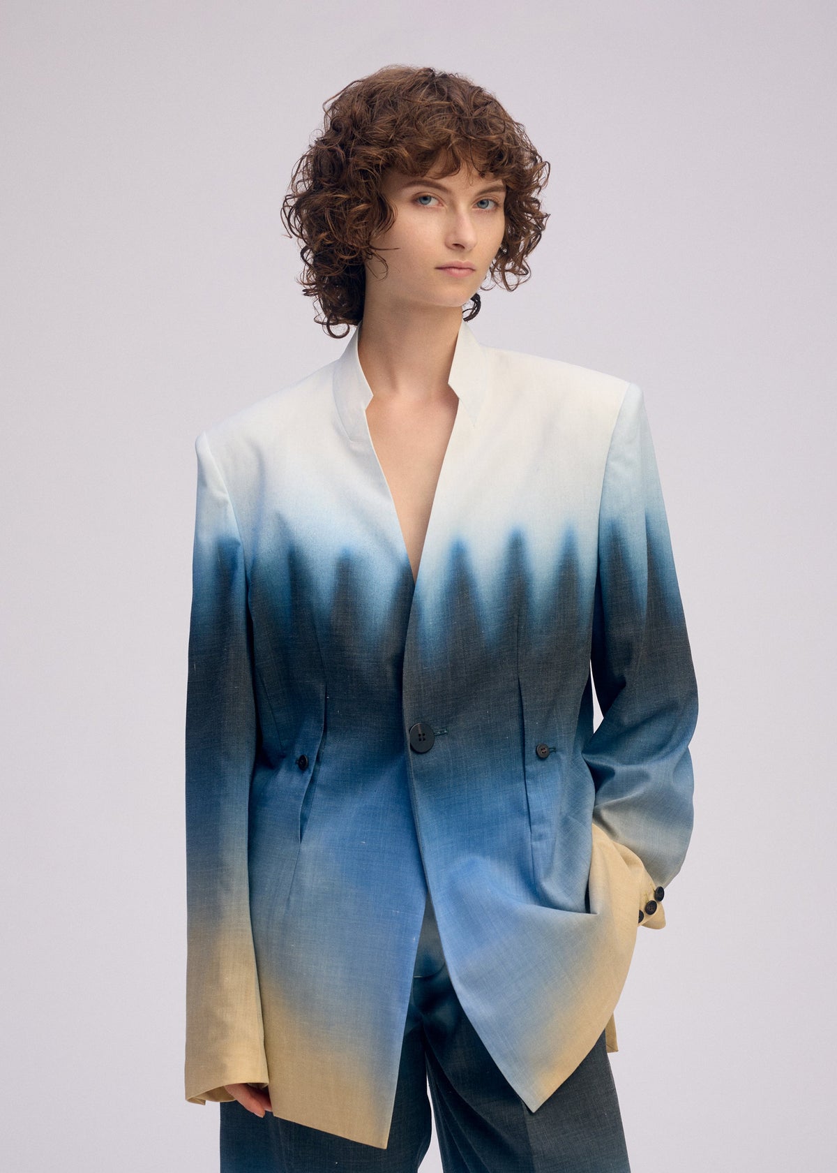 A model wears the ISSEY MIYAKE PLUMAGE plumage-jacket-starling-1.