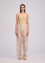 A model wears the Issey Miyake DRAW TO FORM pants.
