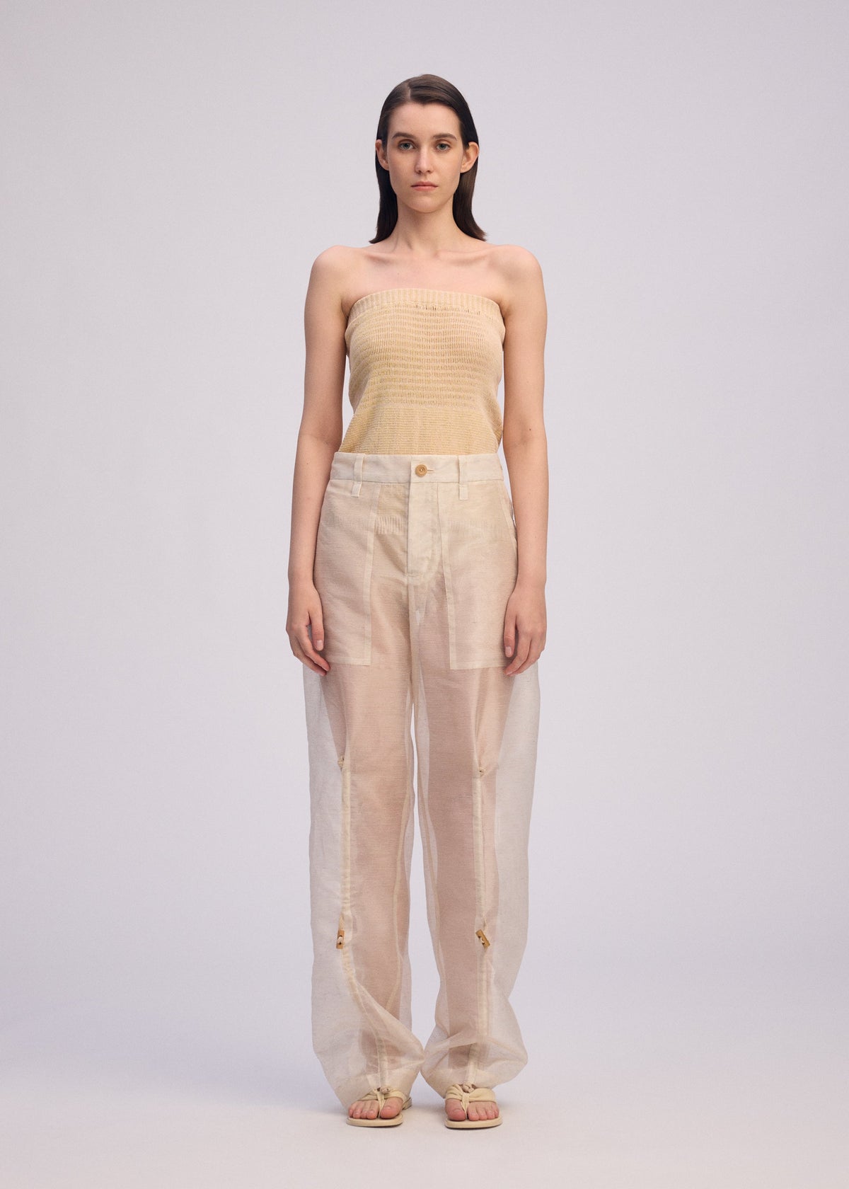 A model wears the Issey Miyake DRAW TO FORM pants.