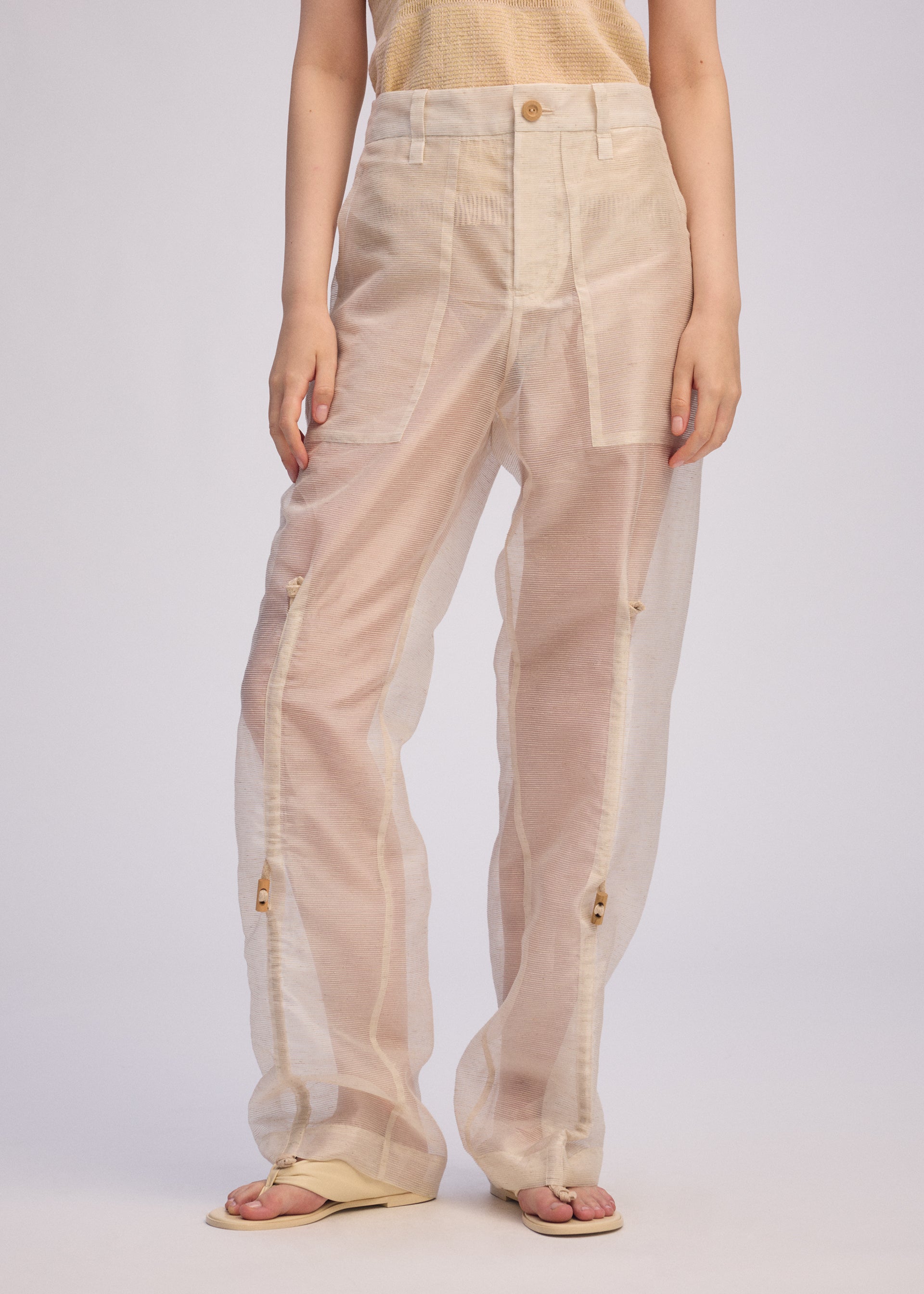 A model wears the Issey Miyake DRAW TO FORM pants.