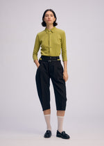 A model wears the Issey Miyake BELTED WOOL PANTS prêt à porter.