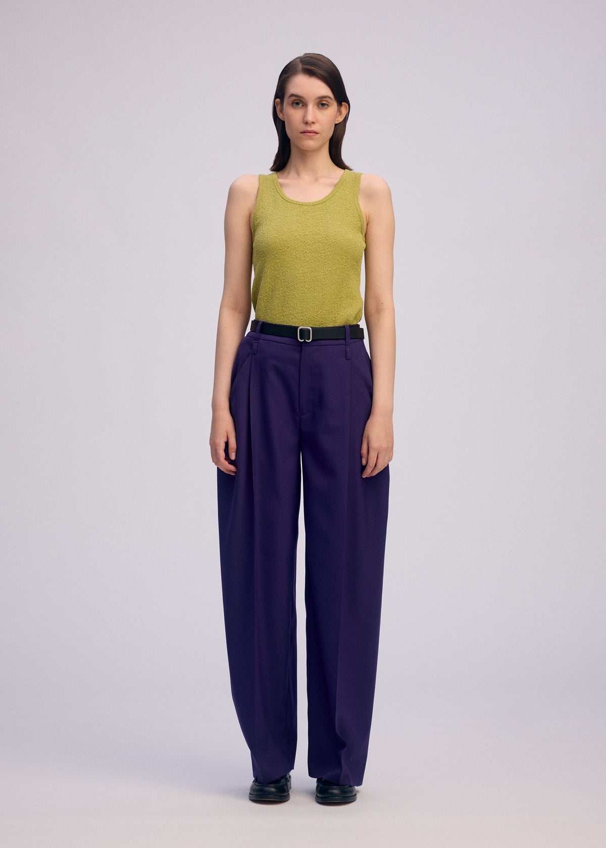 A model wears the Issey Miyake BELTED WOOL PANTS prêt à porter.