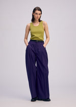 A model wears the Issey Miyake BELTED WOOL PANTS prêt à porter.